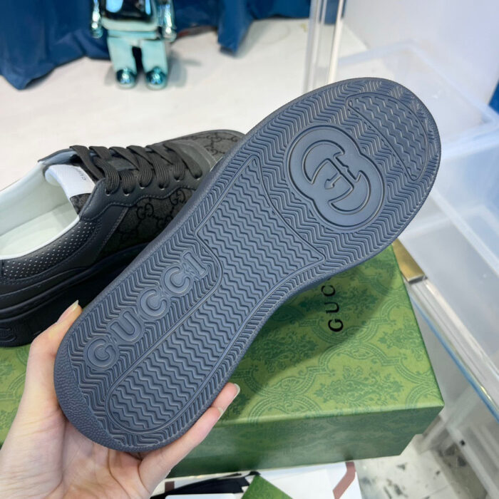 Sneaker Gucci con suola antiscivolo e logo iconico in ambiente retail di lusso.