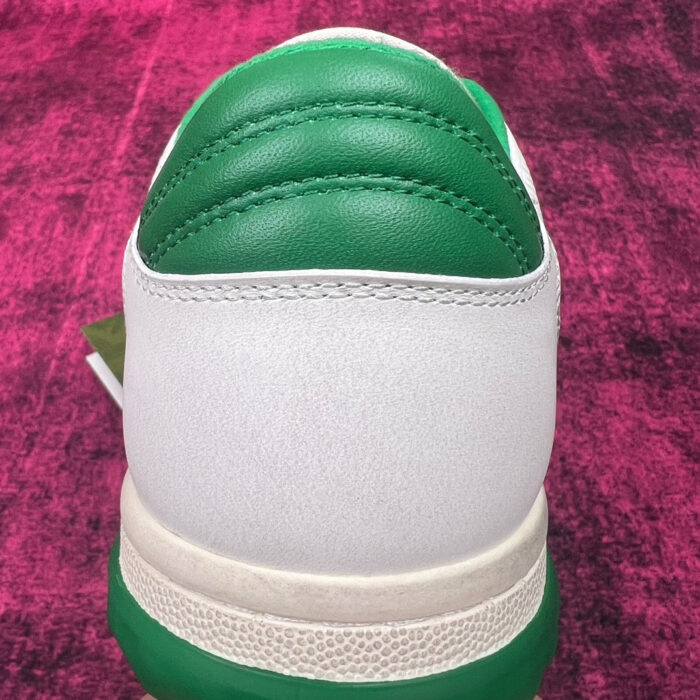 Sneaker bianca con dettaglio verde, design moderno, per sport e casual in stile energico.