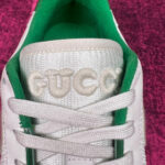 Sneaker Gucci bianca con dettagli verdi e ricamo elegante sul fronte.