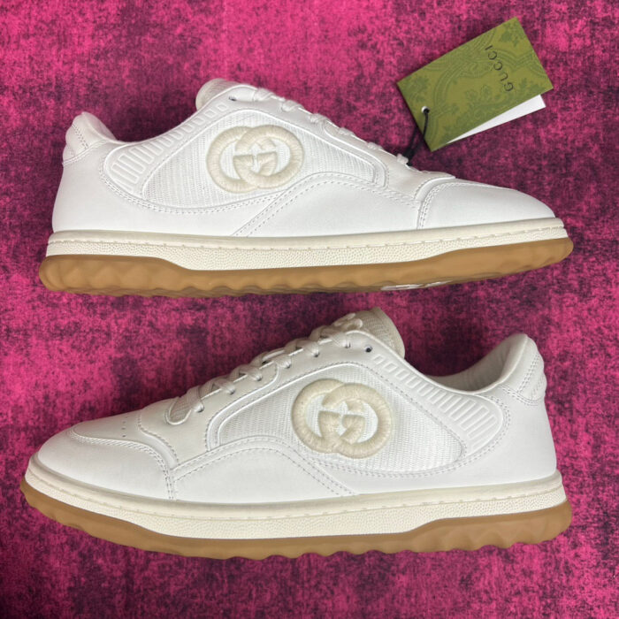 Sneakers di lusso bianche con suola in gomma rossa, design elegante e dettagli raffinati.