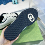 Sneaker di lusso con suola blu, logo iconico e design moderno, ideale per stile e performance.