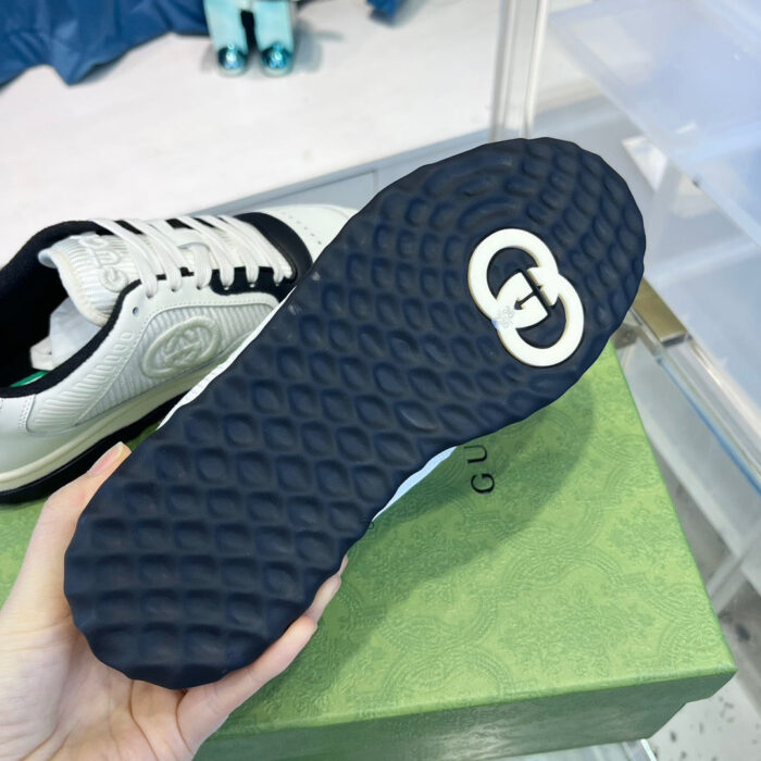 Sneaker di lusso con suola blu, logo iconico e design moderno, ideale per stile e performance.