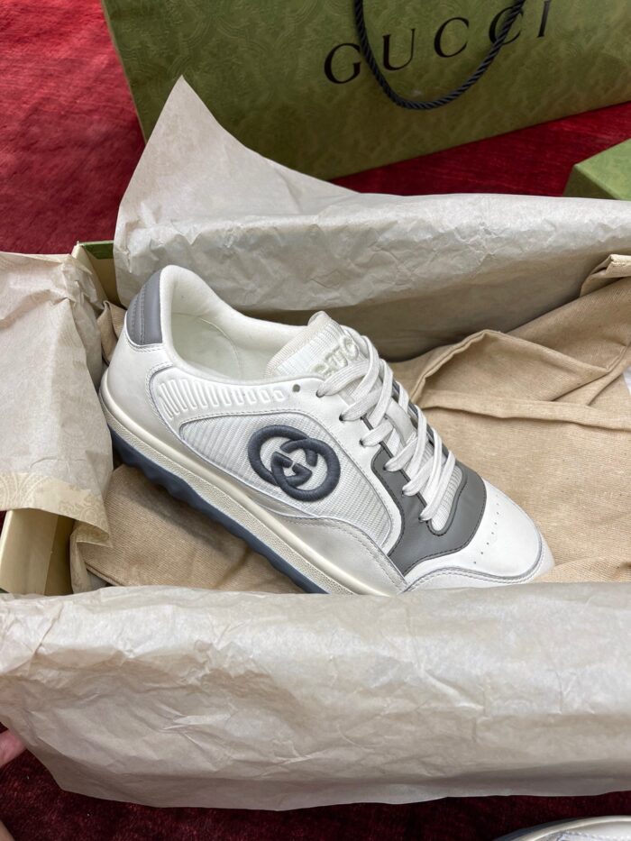 Sneaker Gucci bianca e grigia in elegante confezione di lusso con logo iconico.