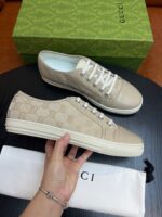 Sneakers Gucci in pelle beige con monogramma, dettagli premium e scatola iconica.