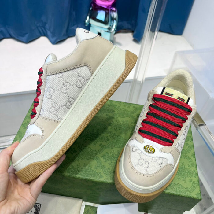 Sneakers di lusso con logo, lacci rossi e suola in gomma per uno stile elegante e casual.