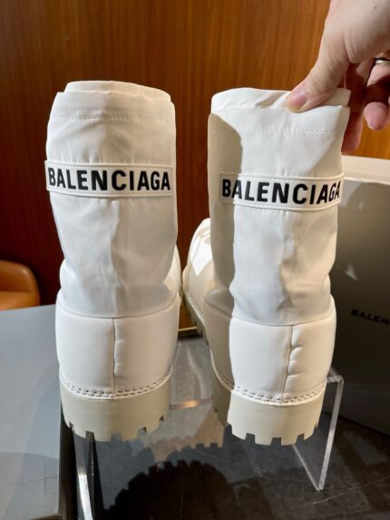 Stivaletti Balenciaga in bianco con logo nero, design moderno e stile streetwear di lusso.