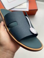 Sandali slide navy con design moderno, logo metallico e suola ergonomica elegante.