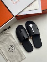 Sandali slide neri eleganti con dettagli di lusso, packaging esclusivo e design raffinato.