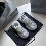 Sneakers di lusso futuristiche su dust bag nero, con scatole minimaliste grigie eleganti.