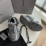 Scarpe Balenciaga athletic in mesh grigia con dust bag e etichetta, stile moderno e di lusso.