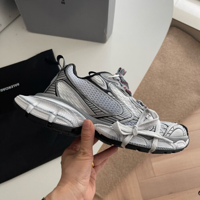 Sneaker moderna in tessuto mesh con lacci elastici e suola ammortizzata, ideale per sport e streetwear.