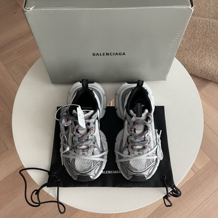Sneaker Balenciaga di lusso su tavolo bianco, stile moderno e dettagli raffinati.