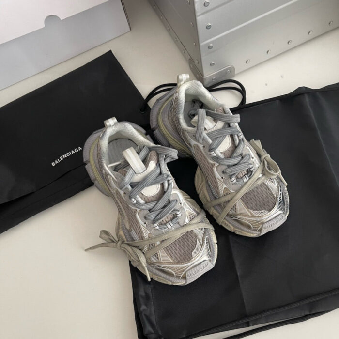 Sneakers moderne grigio con scatola elegante e custodia nera, stile sportivo e raffinato.