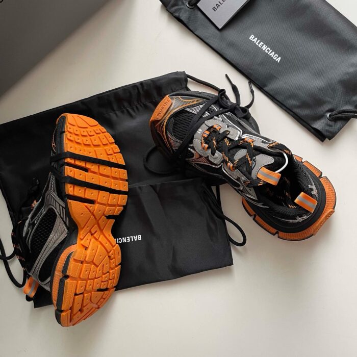 Scarpe sportive di lusso Balenciaga con borse nere e dettagli arancioni.
