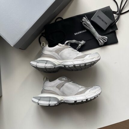 Scarpe da ginnastica di lusso con laccetti extra e packaging elegante, stile moderno e raffinato.