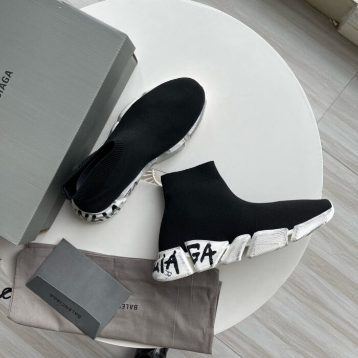 Sneakers Balenciaga high-top neri, stile sportivo e di lusso, su tavolo chiaro con scatola.