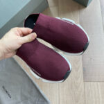 Sneakers di lusso rosso borgogna con design minimalista e suola bianca moderna.