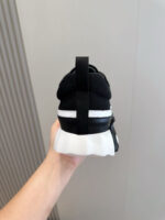 Sneaker nera sportiva con dettaglio bianco e suola moderna, stile trendy e comfort massimo.