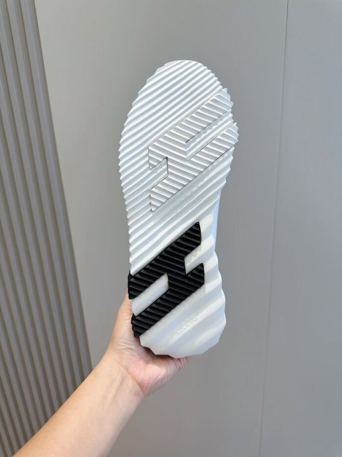 Scarpa da ginnastica con suola bianca, logo H nel centro e design elegante e sportivo.