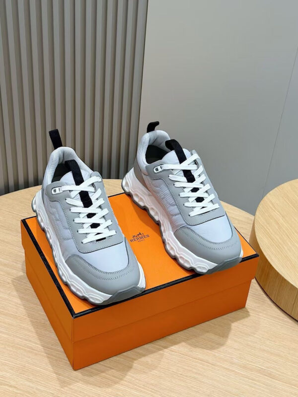 Sneakers moderne su scatola arancione, stile elegante e design versatile per ogni occasione casuale.