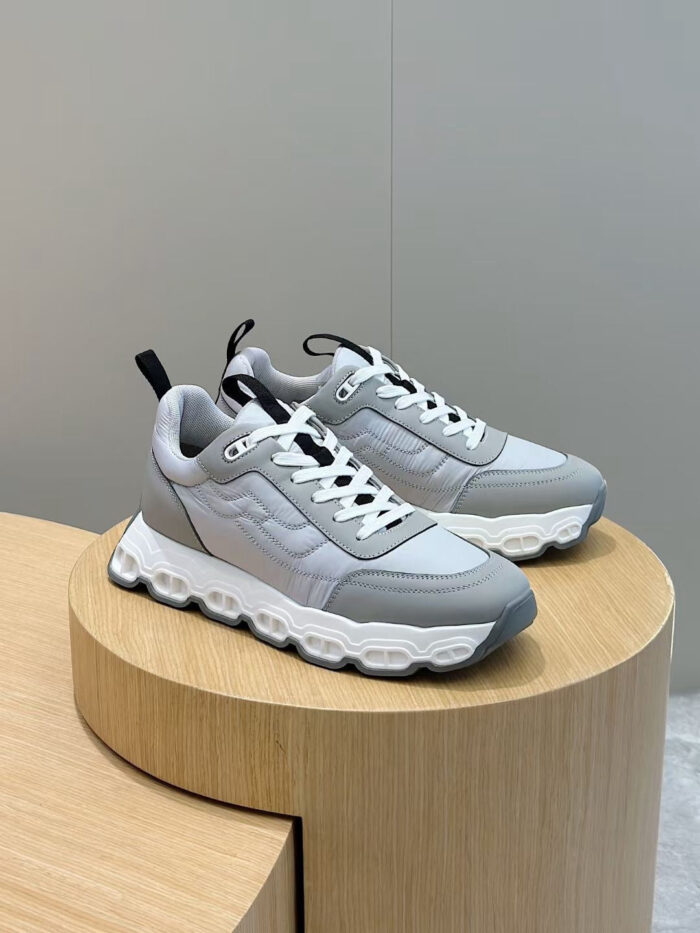 Sneakers grigie moderne con suola bianca, design minimalista e comfort, perfette per uno stile casual.