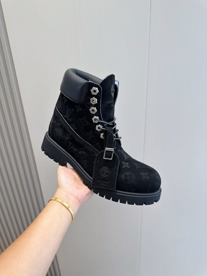 Stivale nero in pelle e suede con dettagli metallici, stile moderno e versatile, perfetto per ogni occasione.