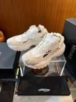 Sneakers di lusso moderne su stand di design con scatole esclusive e dettagli eleganti.