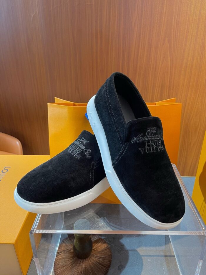 Scarpe slip-on nere in suede con suole bianche, stile moderno e versatile per ogni occasione.