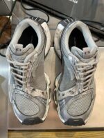 Sneakers moderne in grigio con design sportivo, comfort e stile per ogni outfit casual.