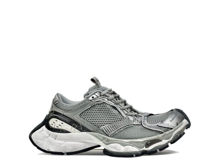Sneaker grigia moderna con suola spessa, design sportivo e comfort elevato per ogni attività.