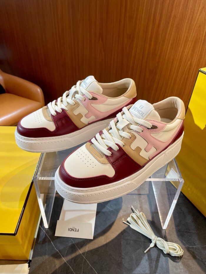 Sneakers donna moderne in maroon, rosa e beige, stile casual chic su pedana trasparente.