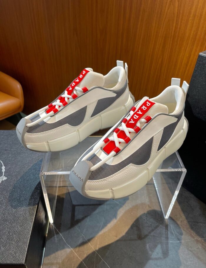 Sneakers moderne con lacci rossi, design elegante e suola robusta, perfette per stile casual estivo.
