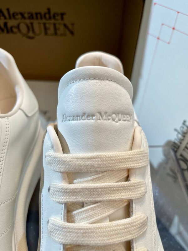 Sneaker Alexander McQueen bianco in stile minimalista, design elegante e dettagli di lusso.
