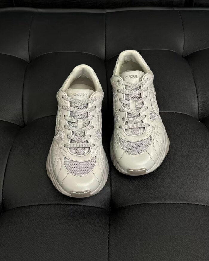 Scarpe sportive grigie moderne su sfondo nero, dettaglio di design e comfort.