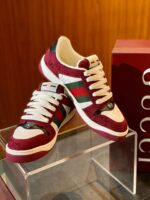 Sneakers di lusso in burgundy, bianco e verde con dettagli eleganti e design moderno.