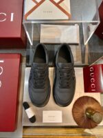 Sneaker Gucci neri di lusso in vetrina, packaging elegante e accessori esclusivi.