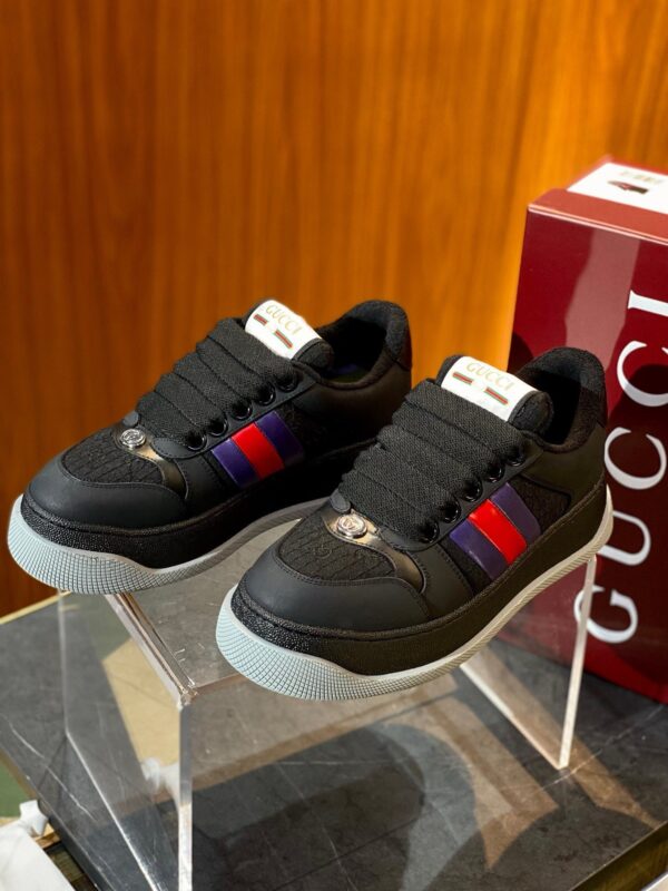 Sneakers Gucci nere con dettagli colorati, design elegante e suola in gomma resistente.