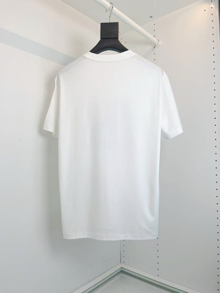T-shirt bianca classica, semplice ed elegante, appesa su appendino moderno per stile minimalista.