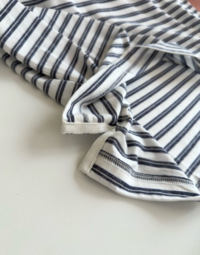 Maglietta a righe navy e bianco, tessuto morbido e finiture di qualità, stile casual e versatile.