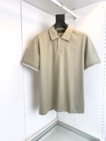 Maglia polo beige versatile, elegante con logo sottile, perfetta per look casual e raffinati.