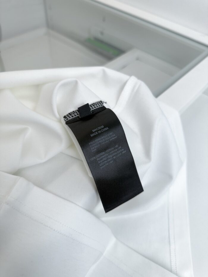 Tessuto bianco con etichetta nera minimalista, stile elegante e di alta qualità.