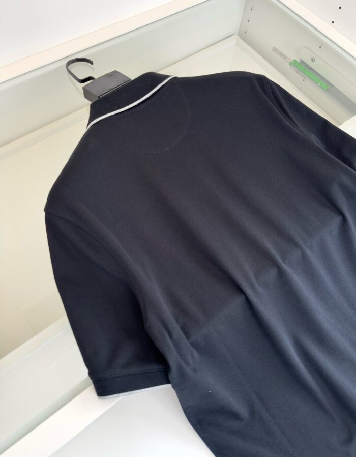 Maglia polo nera con piping bianco elegante, perfetta per ogni occasione elegante o casual.
