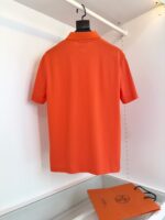 Maglietta polo arancione con borsa coordinata in vetrina, stile moderno e colorato.