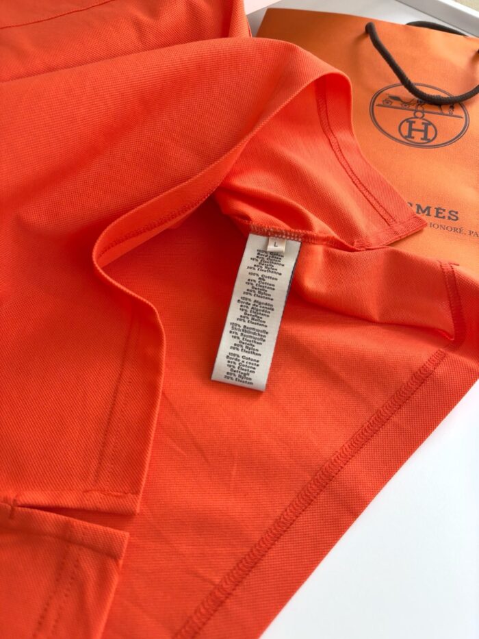 Maglietta arancione di qualità con etichetta e confezione elegante, stile vivace e moderno.