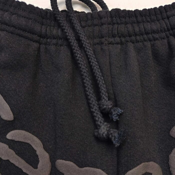 Pantaloni sportivi neri con coulisse, elastico e logo grafico per uno stile casual e comodo.