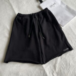 Shorts neri Celine casual, luxury, in tessuto morbido con logo in bianco.