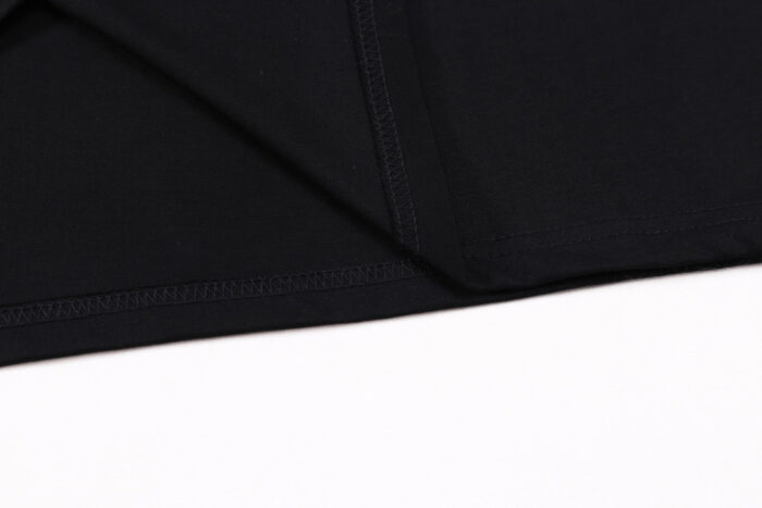 Tessuto nero elegante, morbido e resistente, ideale per abbigliamento casual e moderno.