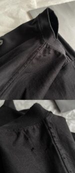 Dettaglio di camicia nera in tessuto morbido con colletto stondato e cuciture precise.