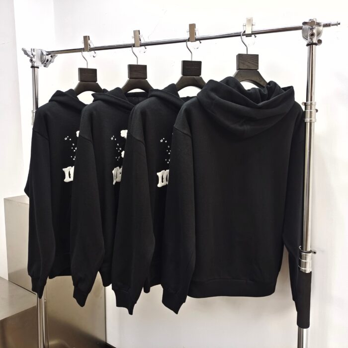 Esposizione di felpe nere minimaliste in negozio di moda contemporanea.