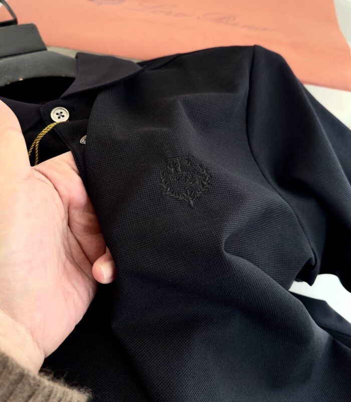 Maglietta polo nera di alta qualità con logo discreto e design elegante.